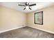 This bedroom has carpeted floors, a ceiling fan, and a window at 256 Grist Mill Ln, Lawrenceville, GA 30046