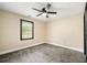 This bedroom has carpeted floors, a ceiling fan, and a window at 256 Grist Mill Ln, Lawrenceville, GA 30046