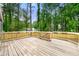 Spacious wood deck with railings overlooking a wooded yard at 256 Grist Mill Ln, Lawrenceville, GA 30046
