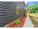 Charming home featuring wood siding and shutters with a walkway leading to the entrance and lush landscaping at 256 Grist Mill Ln, Lawrenceville, GA 30046