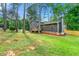 Charming home featuring wood siding, shutters, stone foundation, with a well-maintained lawn and a new fence at 256 Grist Mill Ln, Lawrenceville, GA 30046