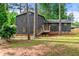 Charming two-story home with wood siding, shutters, stone foundation, and a cozy front porch with beautiful yard at 256 Grist Mill Ln, Lawrenceville, GA 30046