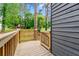 A side angle view of the wooden porch with beautiful railing and flower pots. Wood-sided house with lovely shutters at 256 Grist Mill Ln, Lawrenceville, GA 30046