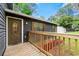 Inviting front porch with wooden railing and a view of the exterior features of the home at 256 Grist Mill Ln, Lawrenceville, GA 30046