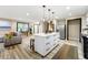 Bright kitchen with center island, modern lighting, stainless appliances and beautiful decor at 256 Grist Mill Ln, Lawrenceville, GA 30046