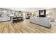 Open-concept living room seamlessly flows into a modern kitchen and dining area with hardwood floors at 256 Grist Mill Ln, Lawrenceville, GA 30046