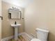 The powder room features a toilet, and a pedestal sink at 256 Grist Mill Ln, Lawrenceville, GA 30046