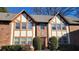 Charming two-story brick townhome featuring Tudor-style accents and well-manicured landscaping at 2825 Northeast Ne Expy # F3, Atlanta, GA 30345