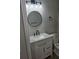 Bathroom with white vanity, granite countertop, and modern light fixture at 3201 Fairington Dr, Lithonia, GA 30038