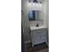 Bathroom with white vanity, granite countertop, modern light fixture, and dark hardware at 3201 Fairington Dr, Lithonia, GA 30038