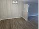 A dining room featuring gray walls, wood floors, and a contemporary light fixture at 3201 Fairington Dr, Lithonia, GA 30038
