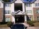 A three story apartment building with brick accents, green shutters, and manicured shrubbery at 3201 Fairington Dr, Lithonia, GA 30038
