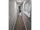 Hallway with wood floors and white trim that leads to an open kitchen with quartz counters at 3201 Fairington Dr, Lithonia, GA 30038