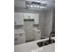 A modern kitchen with white cabinets, black hardware, quartz countertops, and stainless steel appliances at 3201 Fairington Dr, Lithonia, GA 30038