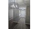 Kitchen view showcases modern lighting, sleek white cabinets, and stainless steel appliances at 3201 Fairington Dr, Lithonia, GA 30038