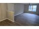 A bright living room with gray walls, wood floors, a modern ceiling fan, and natural light from the windows at 3201 Fairington Dr, Lithonia, GA 30038
