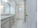 Bright bathroom with a dual sink granite vanity and a tiled stand up shower at 1265 Watercrest Cir, Lawrenceville, GA 30043