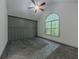 Vaulted ceiling bedroom with arched window, ceiling fan and decorative gray wall paneling at 1265 Watercrest Cir, Lawrenceville, GA 30043