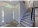 Bright entryway featuring hardwood floors, a staircase with gray accents, and a gray front door at 1265 Watercrest Cir, Lawrenceville, GA 30043