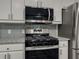 Kitchen boasts stainless steel appliances including a gas range and a microwave at 1265 Watercrest Cir, Lawrenceville, GA 30043