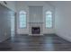 Spacious living room with a fireplace, large windows, and gray wood-look floors at 1265 Watercrest Cir, Lawrenceville, GA 30043