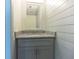 Stylish powder room with shiplap walls, granite countertop, and a gray vanity at 1265 Watercrest Cir, Lawrenceville, GA 30043