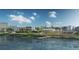 Picturesque waterfront view featuring a lake, walking path, and modern buildings in the background at 2052 Lanier Grv, Alpharetta, GA 30009