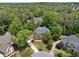 Aerial view of a secluded home surrounded by mature trees in a lovely neighborhood at 330 Broad Leaf Ct, Johns Creek, GA 30022