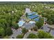 A gorgeous aerial view showcasing community tennis courts, pool, and clubhouse nestled within lush greenery at 330 Broad Leaf Ct, Johns Creek, GA 30022