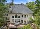 Enjoy outdoor dining on the spacious deck with a table and chairs in this lush backyard at 330 Broad Leaf Ct, Johns Creek, GA 30022