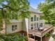 Enjoy outdoor dining on the spacious deck with a table and chairs in this lush backyard at 330 Broad Leaf Ct, Johns Creek, GA 30022