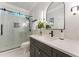 Modern bathroom features a glass-enclosed shower, sleek vanity, and stylish lighting fixtures at 330 Broad Leaf Ct, Johns Creek, GA 30022