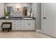 Bathroom vanity area with dual sinks, granite countertop, storage cabinets, and a makeup area with stool at 330 Broad Leaf Ct, Johns Creek, GA 30022
