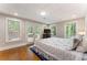 Well-lit bedroom with hardwood floors, double doors, and multiple windows at 330 Broad Leaf Ct, Johns Creek, GA 30022