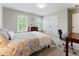 Comfortable bedroom featuring natural light, neutral walls, a large closet, and a desk area for a cozy and productive space at 330 Broad Leaf Ct, Johns Creek, GA 30022