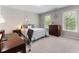 Bright bedroom with natural light, comfortable furnishings, and a desk area, creating a versatile and inviting living space at 330 Broad Leaf Ct, Johns Creek, GA 30022