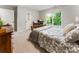 Comfortable bedroom with a window offering natural light and neutral walls, alongside stylish decor for a relaxing space at 330 Broad Leaf Ct, Johns Creek, GA 30022