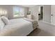 Bright bedroom featuring a window, neutral paint, carpet, dresser, and an ensuite bathroom for added convenience at 330 Broad Leaf Ct, Johns Creek, GA 30022