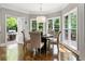 Bright breakfast nook features hardwood floors, modern pendant lighting, and scenic outdoor views at 330 Broad Leaf Ct, Johns Creek, GA 30022