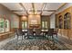 Formal dining room with a coffered ceiling, large windows, and elegant furnishings at 330 Broad Leaf Ct, Johns Creek, GA 30022