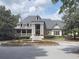Stunning exterior of a home with a water fountain, columns, and a well-manicured lawn at 330 Broad Leaf Ct, Johns Creek, GA 30022