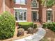 Elegant brick home featuring a detailed front entrance with decorative landscaping at 330 Broad Leaf Ct, Johns Creek, GA 30022