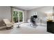 Well-lit home office includes large windows, comfortable seating, and a functional workspace at 330 Broad Leaf Ct, Johns Creek, GA 30022
