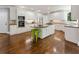 Charming kitchen featuring white cabinets, stainless appliances, kitchen island with bar stool seating at 330 Broad Leaf Ct, Johns Creek, GA 30022