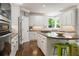Charming kitchen with white cabinets, stainless appliances, granite countertops and hardwood floors at 330 Broad Leaf Ct, Johns Creek, GA 30022