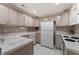 Efficient kitchenette featuring bright appliances, white cabinets, and ample counter space at 330 Broad Leaf Ct, Johns Creek, GA 30022