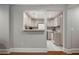 Compact kitchenette with white appliances, neutral cabinetry, and a tiled floor at 330 Broad Leaf Ct, Johns Creek, GA 30022