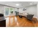 Bright living room with hardwood floors, natural light, and comfortable seating area at 330 Broad Leaf Ct, Johns Creek, GA 30022