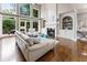 Bright living room featuring a fireplace, built-in shelving, and a wall of windows overlooking the deck at 330 Broad Leaf Ct, Johns Creek, GA 30022