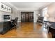 Well-lit office space featuring hardwood floors, built-in shelving, and neutral wall color at 330 Broad Leaf Ct, Johns Creek, GA 30022